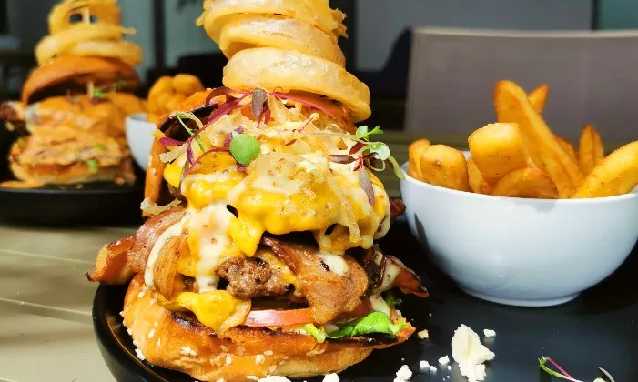 200g Gourmet Burgers with Rustic Fries and Onion Rings at The Hyde Hotel