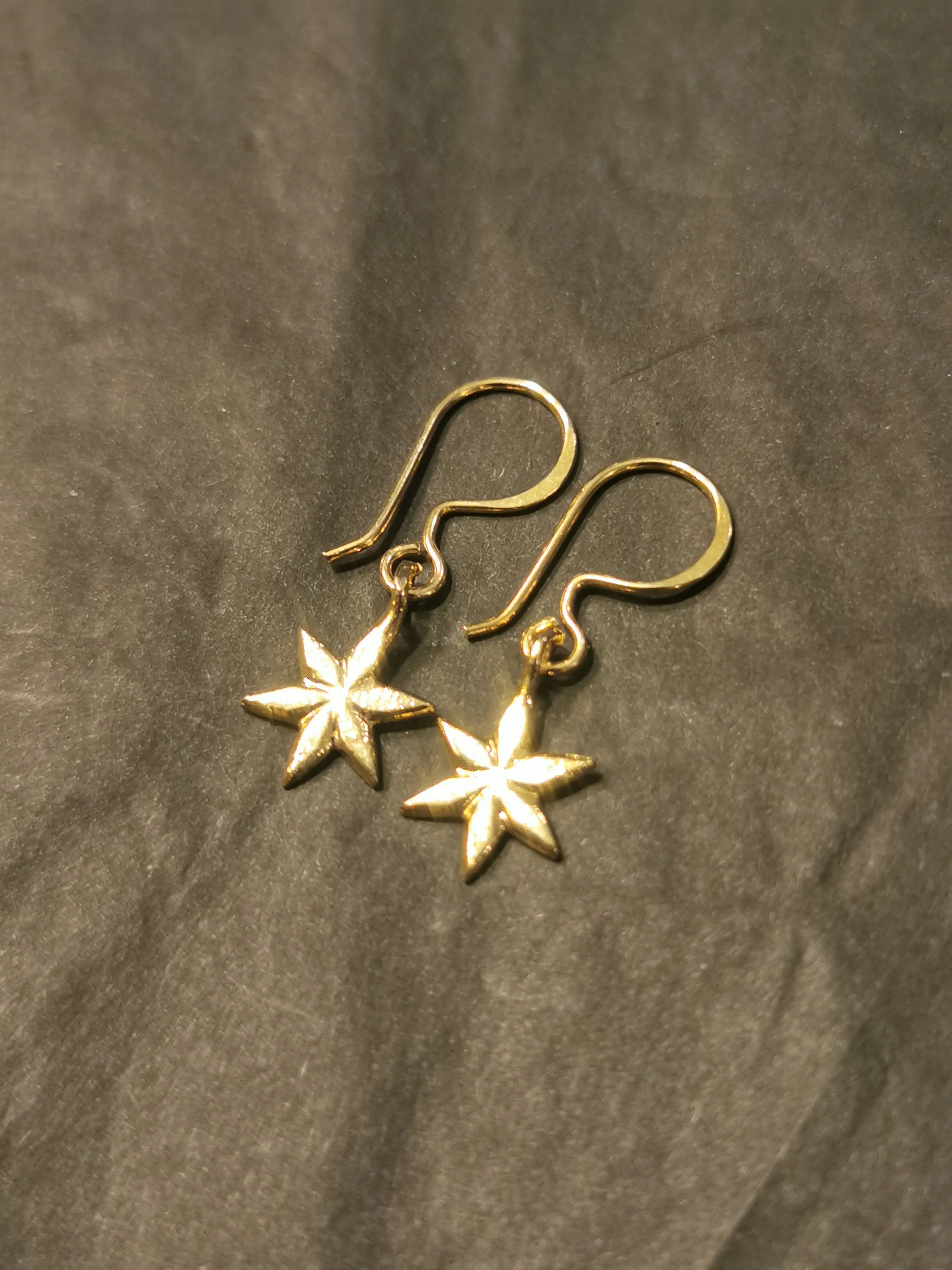 Gold plated star pendant earrings by Mirabelle